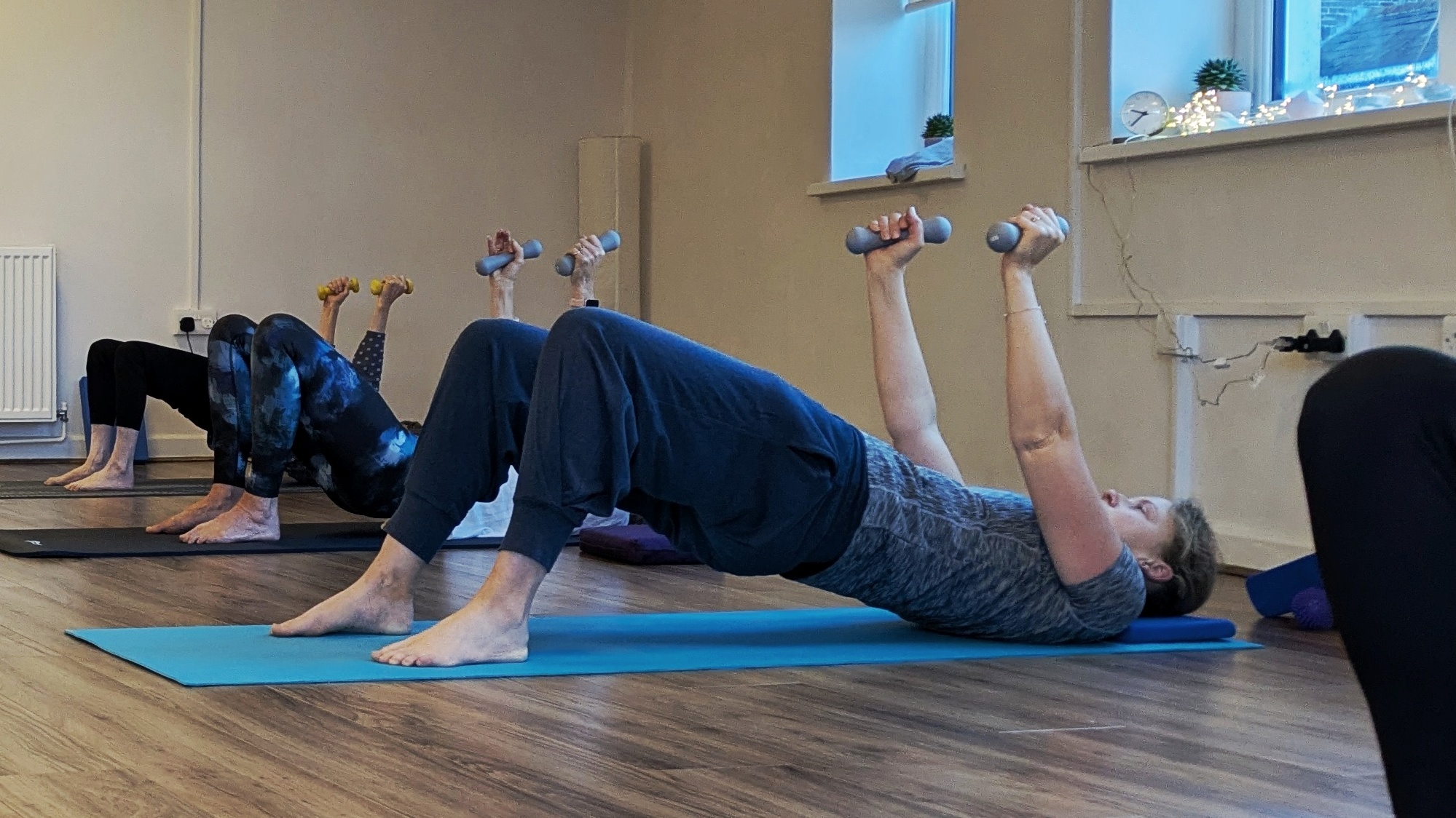 group Pilates class using hand weights
